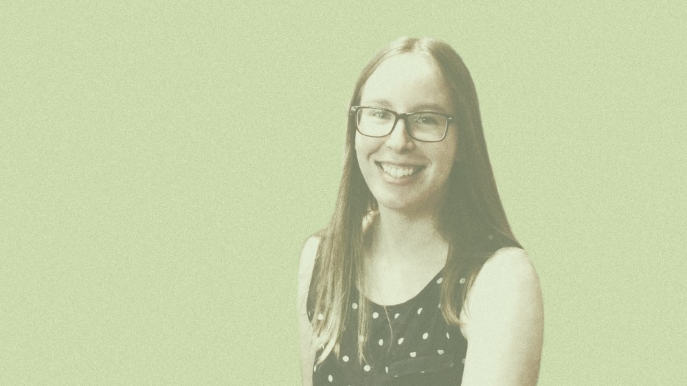 Photo of Joyce Todd in front of a green background.